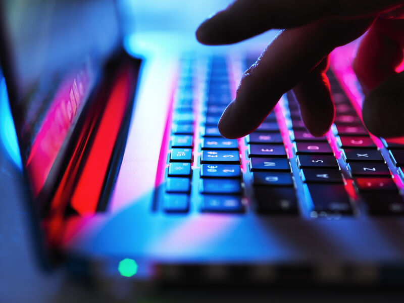 Close‑up of illuminated laptop keyboard in use
